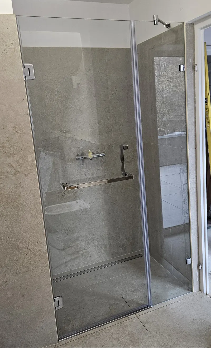 Víztiszta zuhanyajtó fix fallal, hosszú törölközőtartó fogantyúval